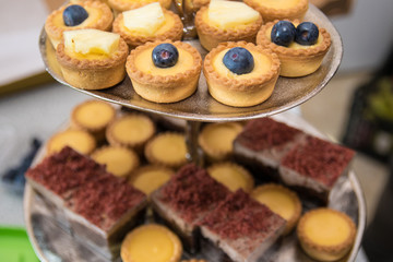 Fruit tartlets dessert and pastry cake sweets on trays