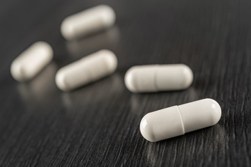White neutral medicine capsules. Oral medication in the form of white capsules for possible text