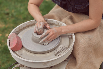hands of potter creating a jar