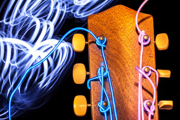 Acoustic guitar with electroluminescent wire for strings