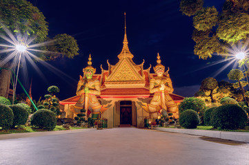 Giants front of the church at Wat Arun. Wat Arun is a Buddhist temple in Bangkok Yai district of Bangkok, Thailand. Wat Arun Temple at sunset in bangkok Thailand.