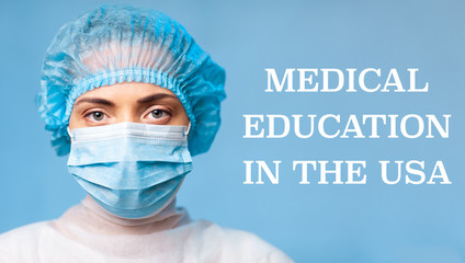 MEDICAL EDUCATION IN THE USA. Portrait of a young woman doctor in a protective mask, a medical cap on a blue background.