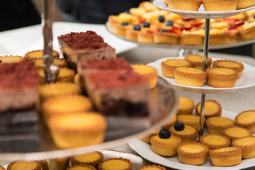 Fruit tartlets dessert and pastry cake sweets on trays