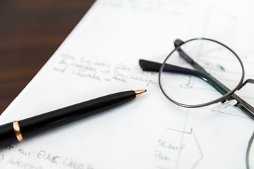 Fototapeta premium notebook with scribbles and glasses