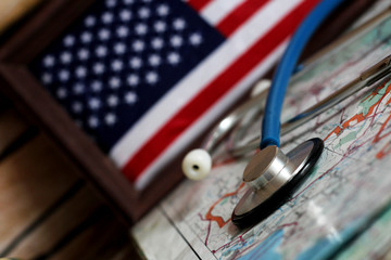 Stethoscope on a globe, U.S. flag in a wooden frame