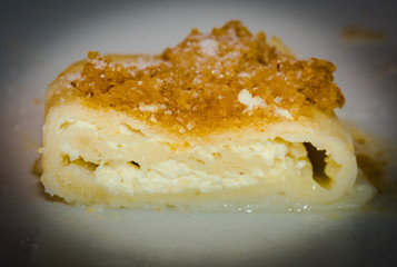 Freshly coocked strukel served with sugar and breadcrumbs broiled on butter.