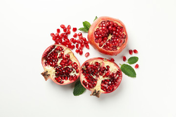 Pomegranate, leaves and seeds on white background, top view