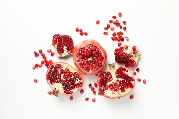 Pomegranate and seeds on white background, top view