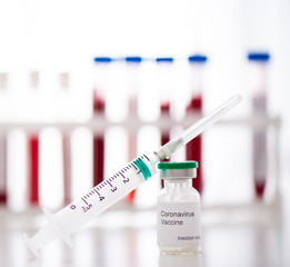 Test tubes with blood sample Covid-19 coronavirus. Vaccine and syringe injection It use for...