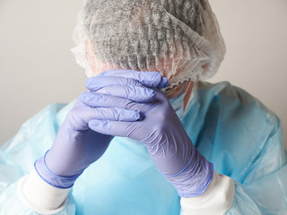 Fototapeta premium Stressed doctor resting his head on his arms