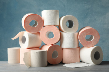 Many rolls of toilet paper against blue background