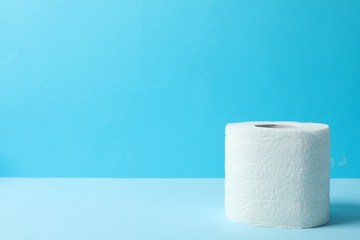 Toilet paper on blue background, space for text