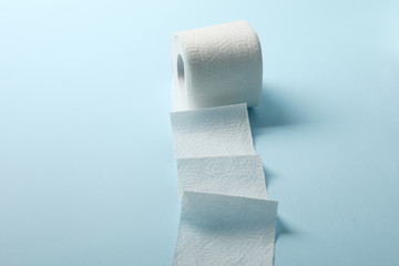 Toilet paper on blue background, space for text