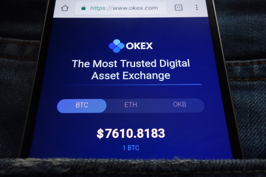 KONSKIE, POLAND - JUNE 02, 2018: OKEX cryptocurrency exchange website displayed on smartphone hidden in jeans pocket