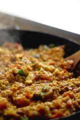 Stir-fry rice with vegetables and eggs in a wok. Selective focus.