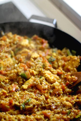 Stir-fry rice with vegetables and eggs in a wok. Selective focus.