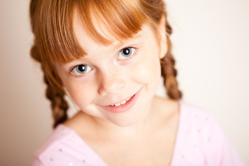 Naklejka premium Happy Little Red Haired Girl with Braids