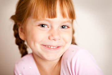 Happy Little Redhead Girl with Braids