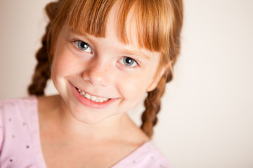 Happy Little Red Haired Girl with Braids