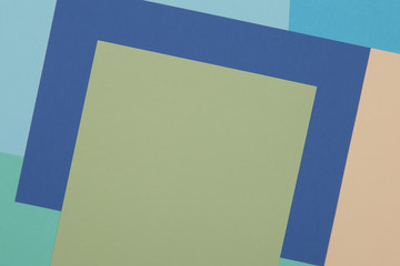 Blue, green, yellow background, colored paper geometrically divides into zones, frame, copy, space.