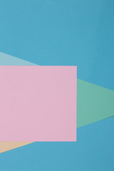 Blue, green and pink background, colored paper geometrically divides into zones, frame, copy, space.