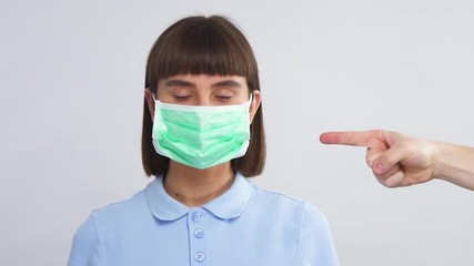 woman standing in protection sterile mask and arm from side pointing on it