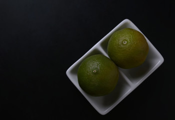 Green lime in a white plate