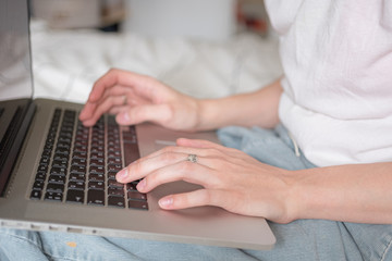 Woman's hands working on laptop at home. Distance work, distance education, home office close up. Selective focus