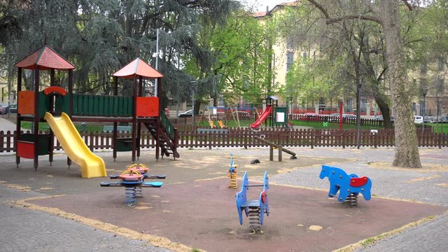 Europe, Italy Milan march 2020 - closure of schools and playgrounds for children in parks - play areas blocked by police tapes by order of the municipality 