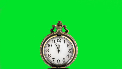 5 minutes to 12 o'clock. Old pocket watch on green background. Copy space area for text. 
