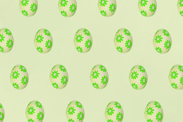 Green Easter eggs on a yellow background. Festive preparation, pattern, repetition, banner.