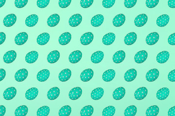 Green Easter eggs on a green background. Festive preparation, pattern, repetition, banner.
