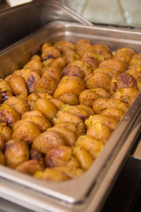 Golden roasted potatos in skin in a hot catering baking food tray
