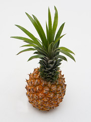 ripe pineapple on a white background wall with shadow top view