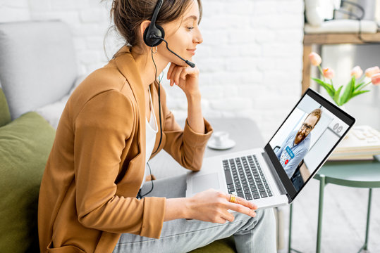 Business Woman Having A Video Call With Coworker, Working Online From Home At Cozy Atmosphere. Concept Of Remote Work From Home