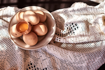 chicken eggs on tablecloth in ray of sunshine