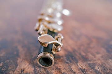  Close up and selective focus on a classic wooden flute on a hardwood background © yackers1