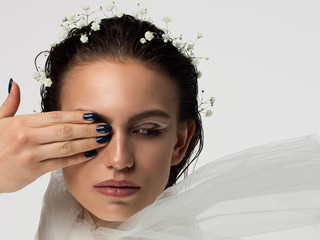 Close up portrait of a face with beautiful skin and nude makeup, eyeliner and long eyelashes, puffy...