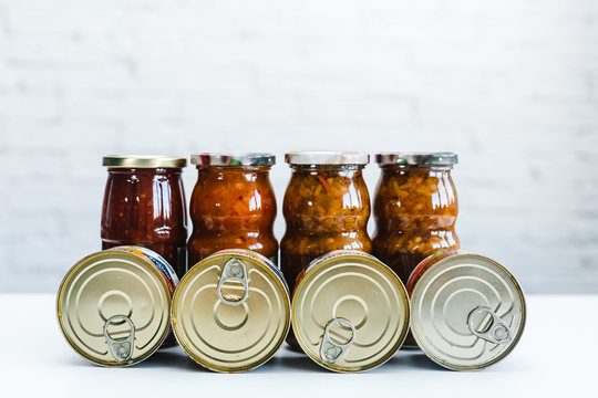 Cans Of Canned Food, Long-stored Foods, Food Supplies For A Difficult Situation. Cans On A White Background