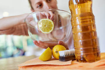 Housewife cleans glass of citric bowl