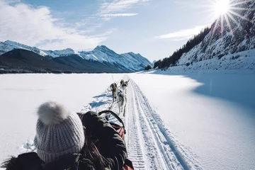 Papier Peint photo Canada Woman sitting in a dog sled on a frozen lake, Spray Lakes, Kananaskis Country, Canadian Rockies, Alberta, Canada