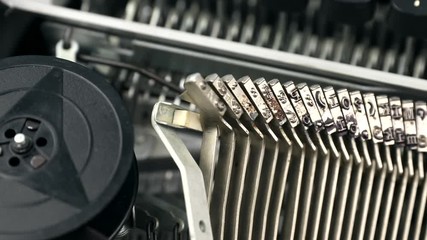 Close-up footage of dirty individual hammers of typewriter. Metal letters and elements of vintage and retro device with copy space. - Powered by Adobe