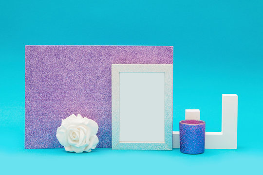 White shiny frame for text with letter object and other decorations on a blue and purple background
