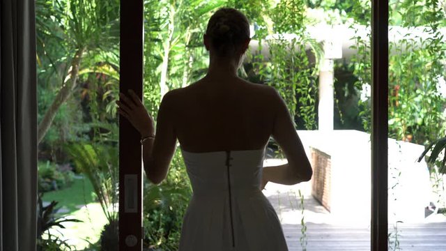 Young happy sexy woman unveil curtains, walking out on garden patio
