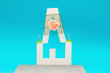 Letter objects with flowers, roses and decorations on a blue background