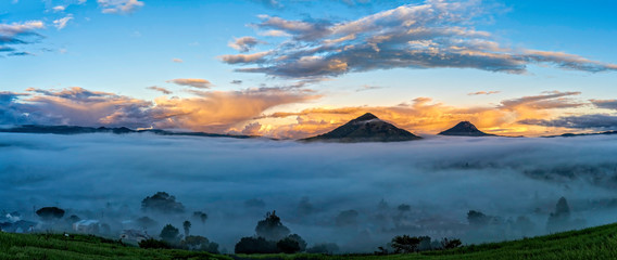 Panorama of Mountain Peaks with Fog at Sunset, sunrise 