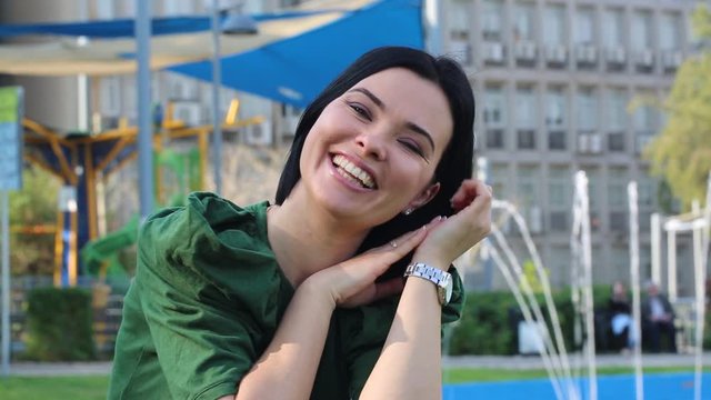 video of cheerful female with candid sincere smile on face and looking at camera, happy carefree woman with white teeth enjoying leisure time and free day outdoors
