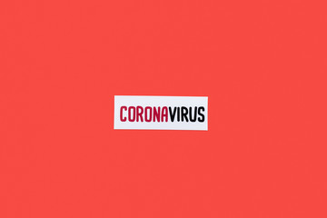 top view of card with coronavirus lettering isolated on red