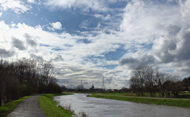 Fototapeta na wymiar In winter, after a lot of rain, the water level of the Demer is very high. Meadows are flooded. Image of the river Demer in Langdorp, near Aarschot, Flanders, Belgium.