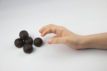 Child's hand reaching for sweets, all on a white background.